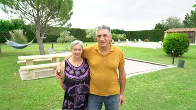 a man and a woman standing in a park at Chambres d'hôtes Le Saint Victor - Provence, Vaucluse in Pernes-les-Fontaines