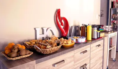 a counter with baskets of bread and vegetables on it at Chambres d'hôtes Le Saint Victor - Provence, Vaucluse in Pernes-les-Fontaines