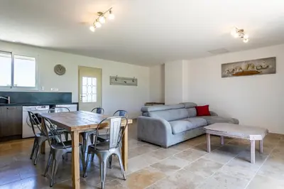 a living room with a table and a couch at Mas Saint Julien in Cavaillon