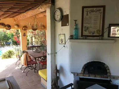 a living room with a fireplace and a table and a clock at FLC - Large Charming House - Swimming Pool in Lambesc