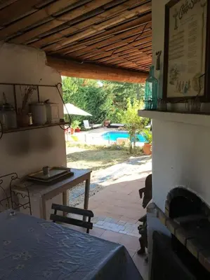 a room with a fireplace and a table and a pool at FLC - Large Charming House - Swimming Pool in Lambesc