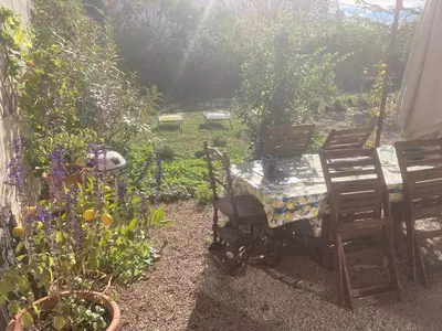 a garden with a table and chairs and flowers at 