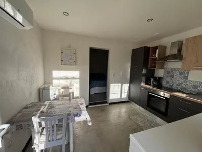 a kitchen with a table and chairs in a room at 