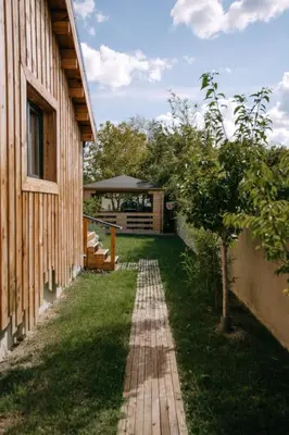 a brick path next to a building with a tree at Charming ecolodge with private access to the river in Le Thor