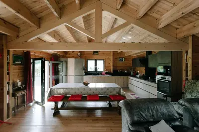a living room with a couch and a table at Charming ecolodge with private access to the river in Le Thor