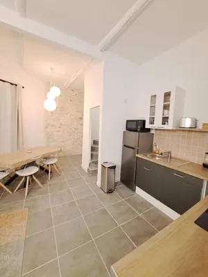 a kitchen and dining room with a table and a dining room at Appartement lumineux , Carpentras centre in Carpentras