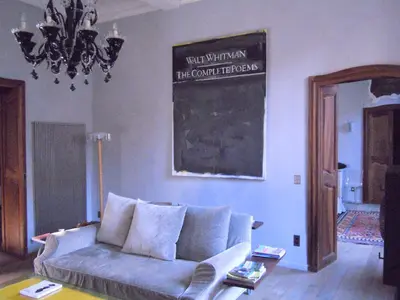 a living room with a couch and a chalkboard on the wall at Luxury two bedroom apartment in Apt, the heart of the Luberon in Apt