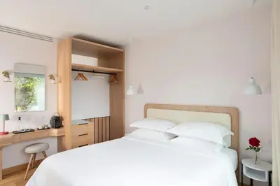 a bedroom with a white bed and a desk at Auberge La Coste in Le Puy-Sainte-Réparade