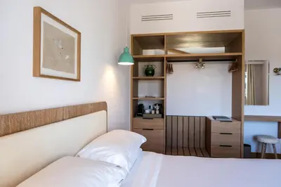 a bedroom with a white bed and a desk at Auberge La Coste in Le Puy-Sainte-Réparade