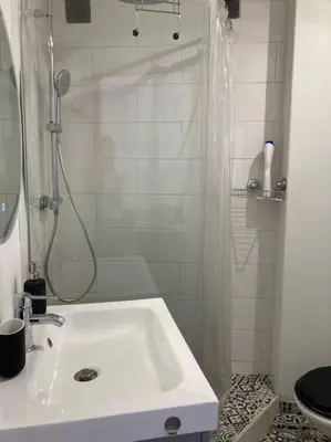 a white bathroom with a shower and a sink at T3 centre ville Historique in Aix-en-Provence