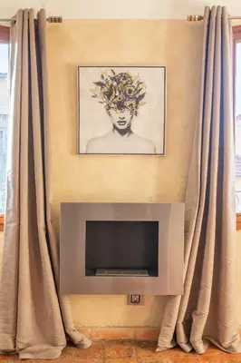 a living room with a tv and curtains at Authentique Appartement Aixois in Aix-en-Provence