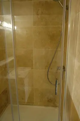 a shower with a glass door in a bathroom at Isabelli Appartement plein centre avec place de parking in Aix-en-Provence