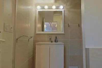 a bathroom with a shower and a sink and a mirror at Isabelli Appartement plein centre avec place de parking in Aix-en-Provence
