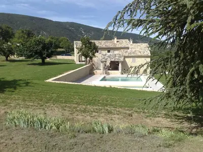 a large house with a swimming pool in a yard at Authentique propriété in Bonnieux