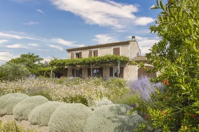 an old house with a garden in front of it at Mas de Lavande in Saint-Rémy-de-Provence