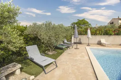 a group of lawn chairs and a swimming pool at Mas de Lavande in Saint-Rémy-de-Provence