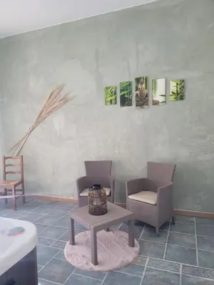 a living room with two chairs and a table at Logement charme provençal in Cabannes
