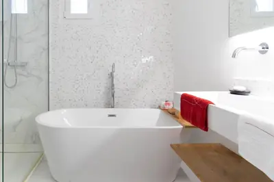 a white bathroom with a tub and a sink at Alma Viva - Piscine Privée - Climatisée - Parking in Velaux