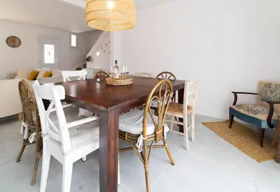 a dining room with a wooden table and chairs at Alma Viva - Piscine Privée - Climatisée - Parking in Velaux