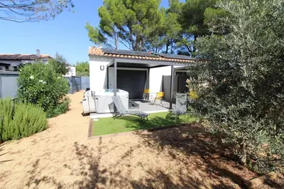 a backyard with a patio with a table and chairs at Pause spa sur la route du Ventoux adults only in Carpentras