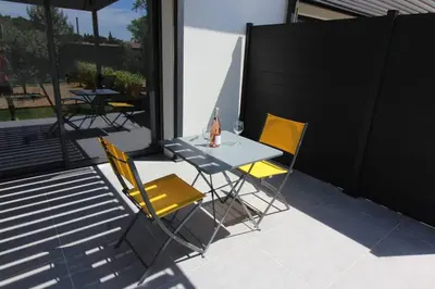 two chairs and a table on a patio at Pause spa sur la route du Ventoux adults only in Carpentras