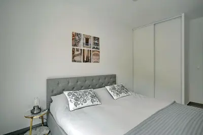 a bedroom with a bed with two pillows on it at Sublime Appartement 6 couchages avec Parking (Aix-en-Provence) in Aix-en-Provence