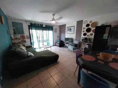 a living room with a couch and a table at L'ETOURNEAU in Bédoin