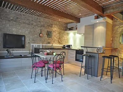 a kitchen with a table and chairs and a tv at Bliss Near Aix-en-Provence in Venelles