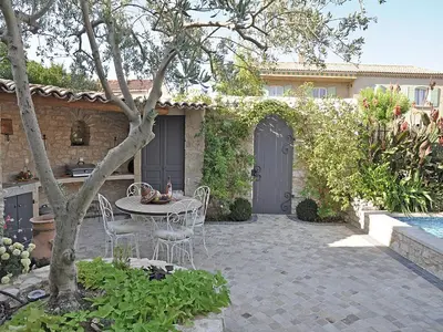 a patio with a table and chairs in front of a house at Bliss Near Aix-en-Provence in Venelles