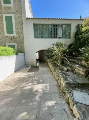 a house with a walk way in front of it at Jacuzzi & Terrasse en bord de rivière in Fontaine-de-Vaucluse