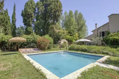 a swimming pool in the yard of a house at Le Mas des Anges in Cabannes