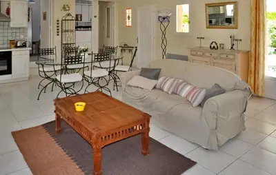 a living room with a couch and a table at La Villa Du Soleil in Lacoste