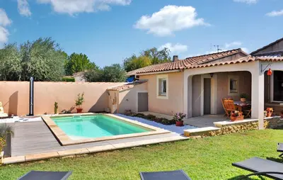 a backyard with a swimming pool and a house at La Villa De Sacha in Vedène