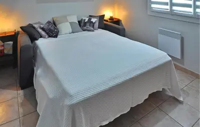 a large white bed sitting in a room at La Villa De Sacha in Vedène