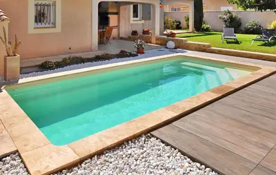 a swimming pool in a yard with a house at La Villa De Sacha in Vedène