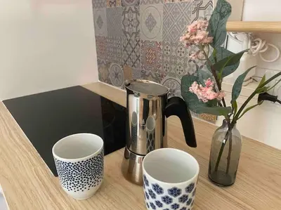 a coffee pot and two cups on a table at Charming Studio to Venelles 10 minutes from Aix in Venelles