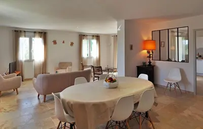 a living room with a table and chairs and a dining room at Li Vue Vent in Saint-Rémy-de-Provence