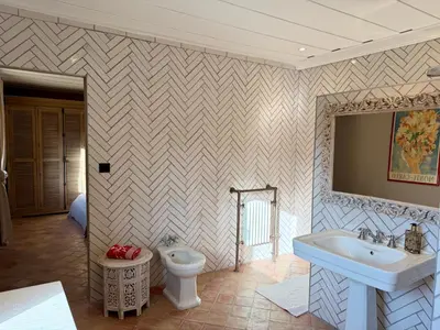 a bathroom with a sink and a toilet at Domaine de Valloncourt in Cheval-Blanc