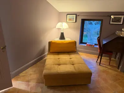 a living room with a couch and a table at Domaine de Valloncourt in Cheval-Blanc
