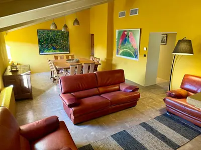a living room with a couch and a table at Domaine de Valloncourt in Cheval-Blanc