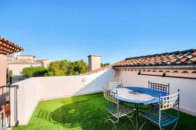 a patio with a table and chairs on a balcony at Village Pont Royal en Provence - maeva Home - Appartement climatisé 3 pièces 4 personnes avec terrasse aménagée - Prestige - super Home MAE-3084 in Mallemort