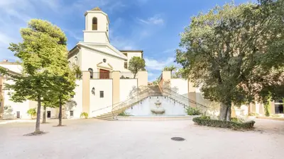 a building with a steeple and a church at Village Pont Royal en Provence - maeva Home - Appartement climatisé 3 pièces 4 personnes avec terrasse aménagée - Prestige - super Home MAE-3084 in Mallemort