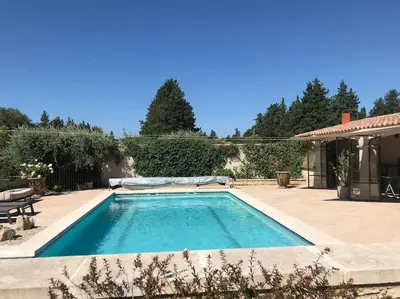 a swimming pool in the backyard of a house at Lou Mas dou Souleou & Spa in Cheval-Blanc