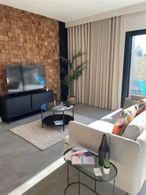 a living room with a couch and a flat screen tv at L'Artiste - Villa 5 min du centre historique d'Aix in Aix-en-Provence
