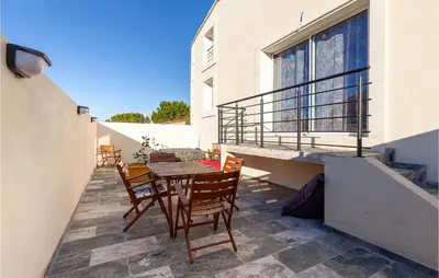 a patio with a table and chairs on a balcony at Beautiful Apartment In Eyragues in Eyragues