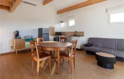 a kitchen and dining room with a table and chairs at Beautiful Apartment In Eyragues in Eyragues