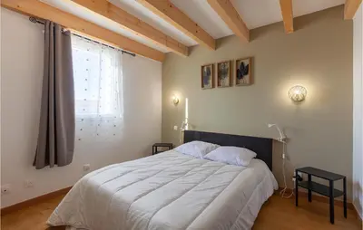 a bedroom with a large bed and a window at Beautiful Apartment In Eyragues in Eyragues