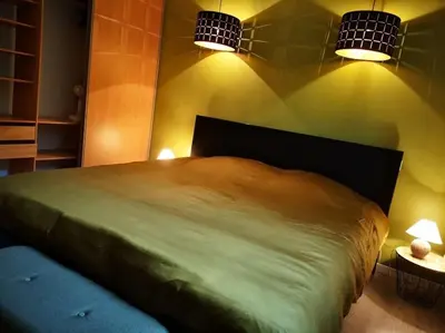 a bedroom with a large bed with two lights at Au goût du miel. Luberon-Provence. in Maubec