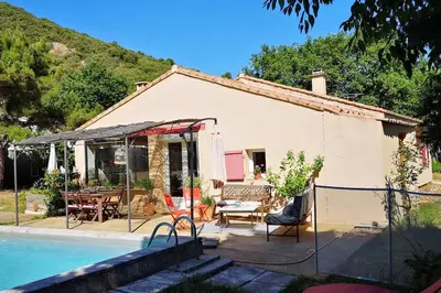 a small house with a swimming pool in front of it at Au goût du miel. Luberon-Provence. in Maubec