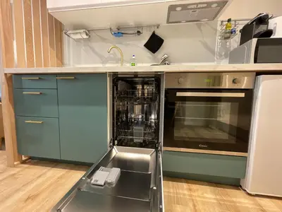 an empty dishwasher in a kitchen with a sink at La Venise Provençale - Hypercentre - Wifi in LʼIsle-sur-la-Sorgue